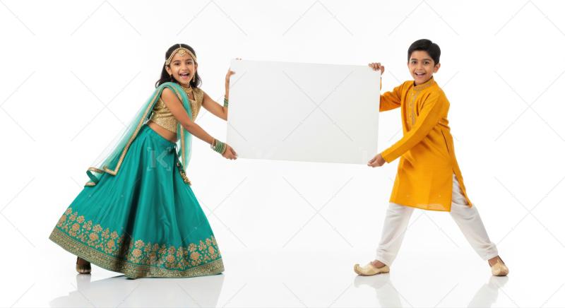 Cheerful Indian kids proudly display blank white promotional sign.