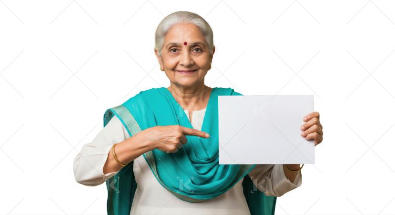 Elderly Indian woman happily points at a blank sign.