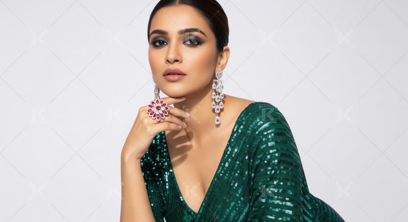Elegant Woman Poses in Green Sequin Saree with Glamorous Jewelry