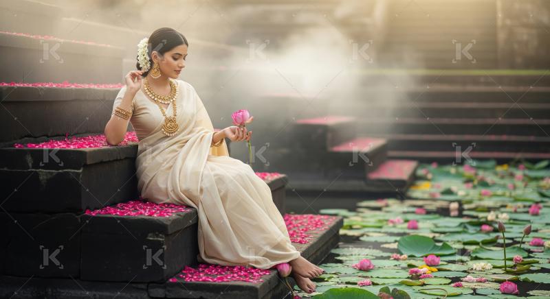 Elegant Indian Woman with Lotus Flower by Misty Pond