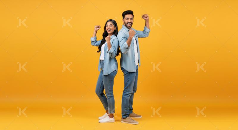 Happy Indian Couple Celebrating Success Together Posing on Yello