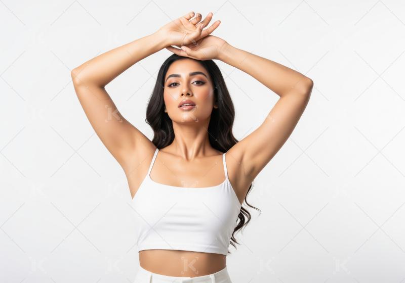 A confident woman with beautiful skin posing elegantly in white