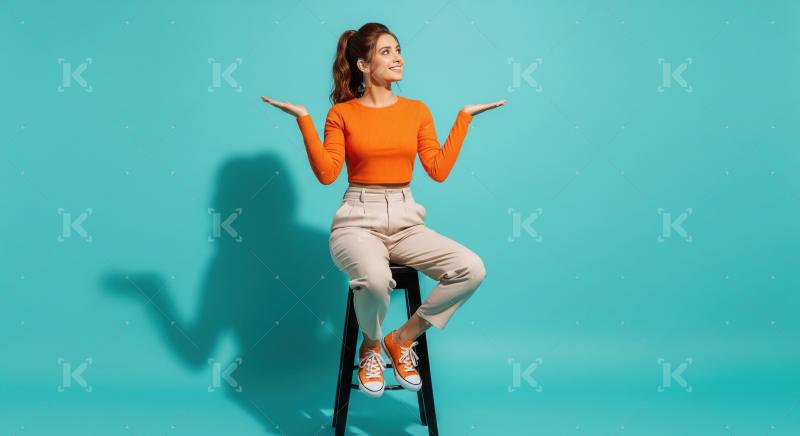 Happy Woman Presenting Ideas on Teal Studio Background