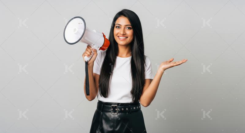 Young beautiful indian woman using megaphone