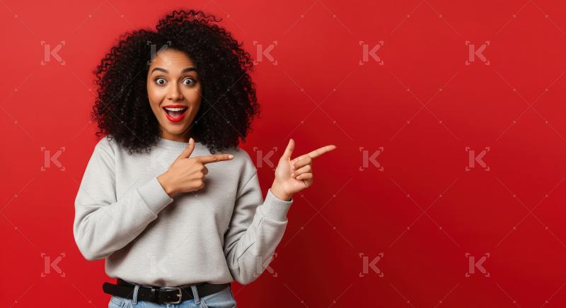 Cheerful young woman pointing with both hands to empty copy spac