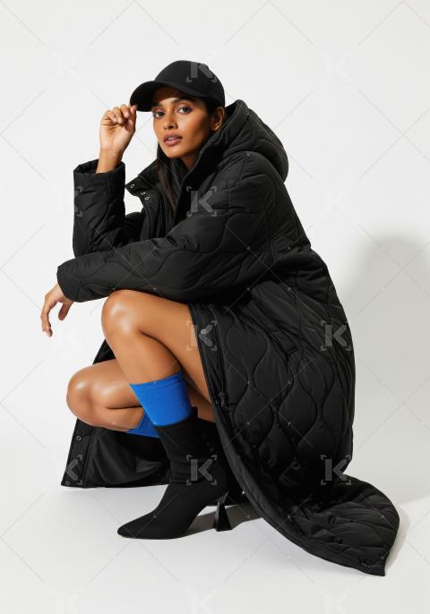 Fashionable Woman in Quilted Black Puffer Coat and Cap