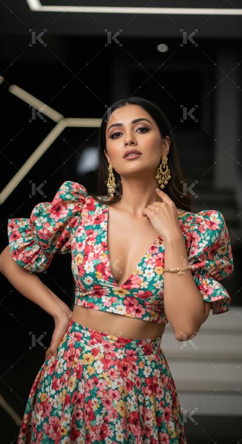 Elegant Woman Posing in Vibrant Floral Crop Top and Skirt