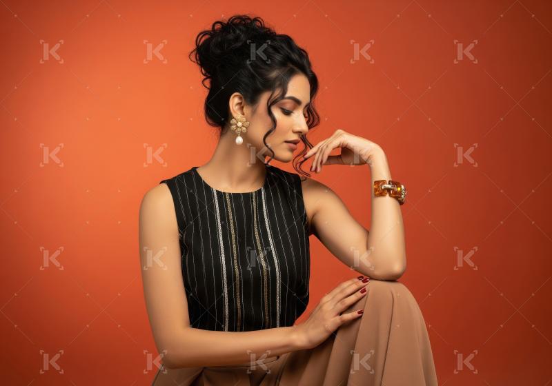 Thoughtful Indian woman showcasing ethnic fashion and elegant je