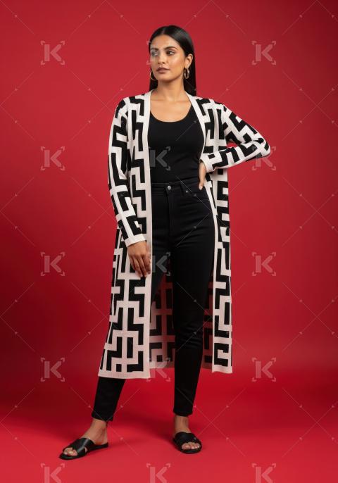 Woman in Geometric Pattern Cardigan and Black Outfit Posing