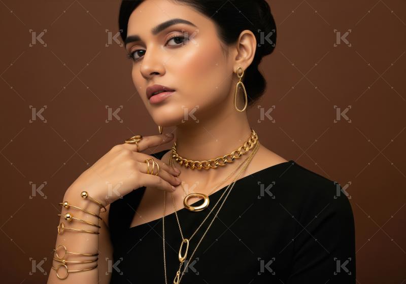 Elegant woman showcasing luxurious gold jewelry collection on br