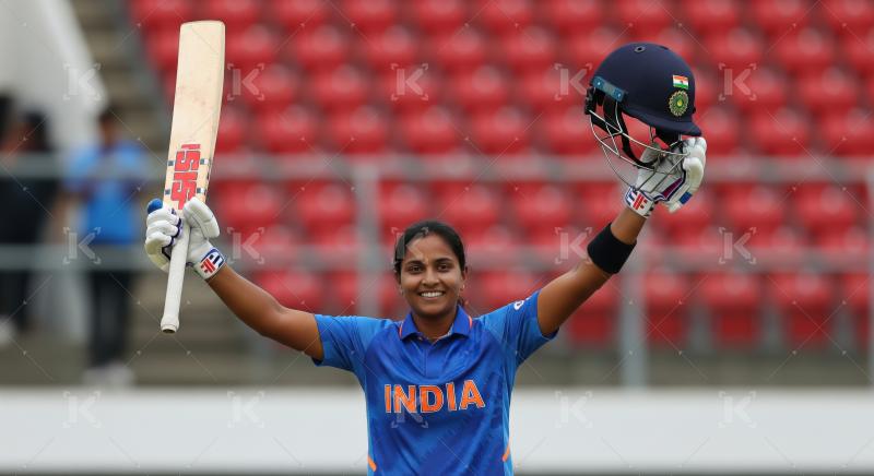 Indian Woman Cricketer Celebrates Victory Holding Bat and Helmet