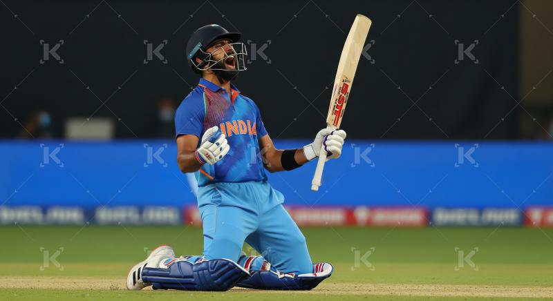 Indian cricketer celebrates victory on field at night match