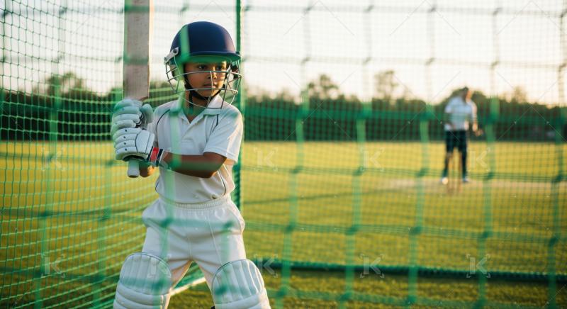Young Boy Practicing Cricket Batting in Training Nets