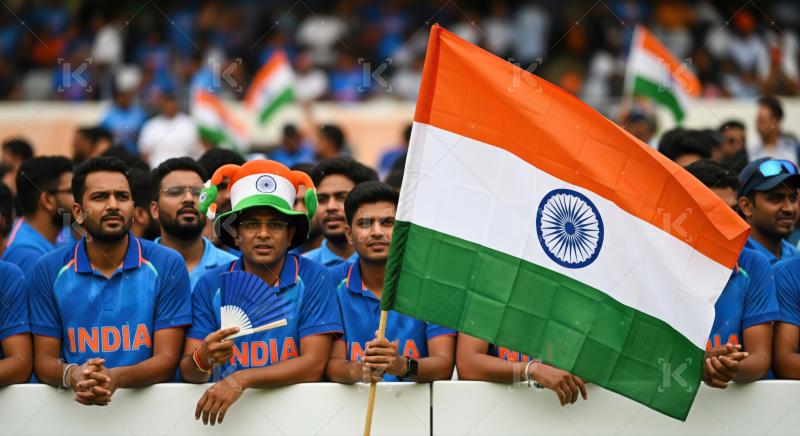 Enthusiastic Indian cricket fans supporting their team with national flag.