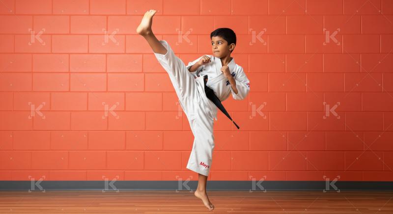 Young Boy Performing Dynamic Karate High Kick with Precision