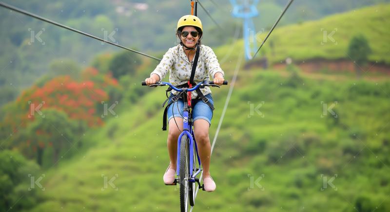 Happy Woman Enjoying Thrilling Sky Cycling Adventure in Nature