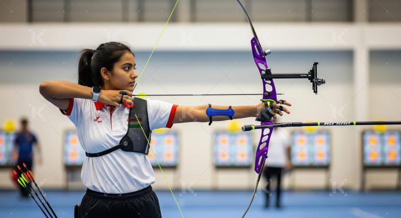 Young Indian Archer Aiming Recurve Bow at Indoor Range