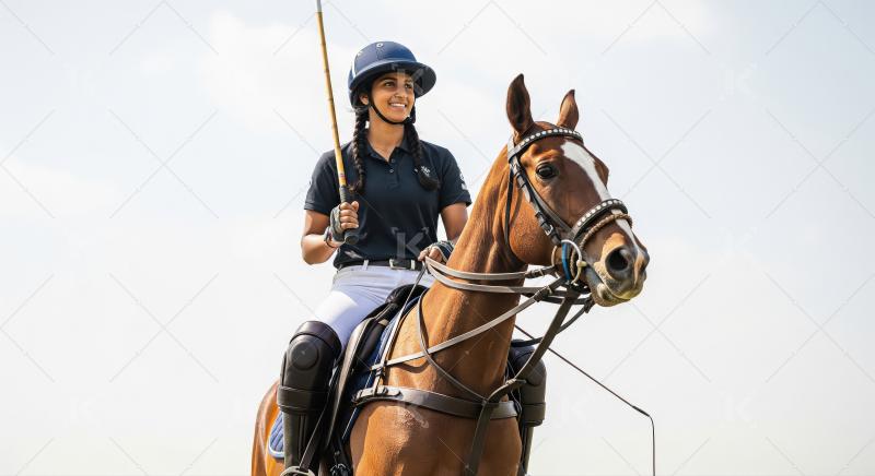 Confident Female Polo Player and Horse on Sunny Day