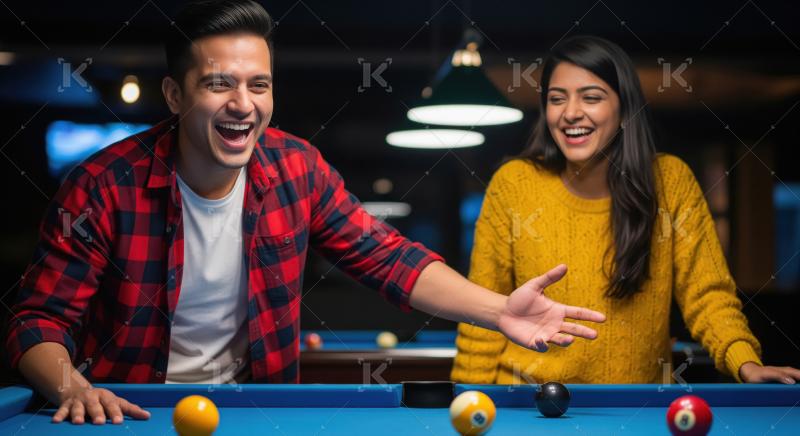 Young Indian man and woman laugh playing billiards