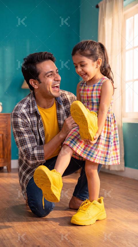 Happy indian father and daughter enjoying together at home