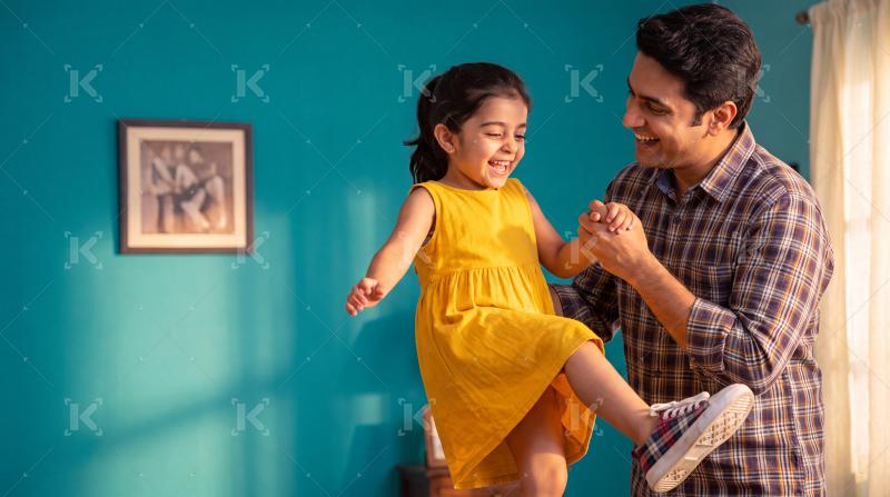 Happy indian father and daughter enjoying together at home