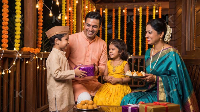 Happy Indian Family Celebrating Festival with Gifts and Sweets