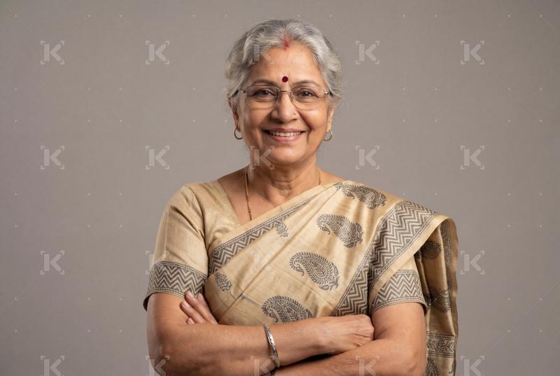 Happy indian senior woman standing on isolated background