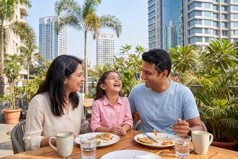 Happy indian family enjoying a relaxed outdoor meal together