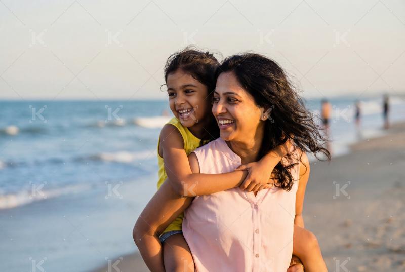 Happy indian family enjoying on sea beach
