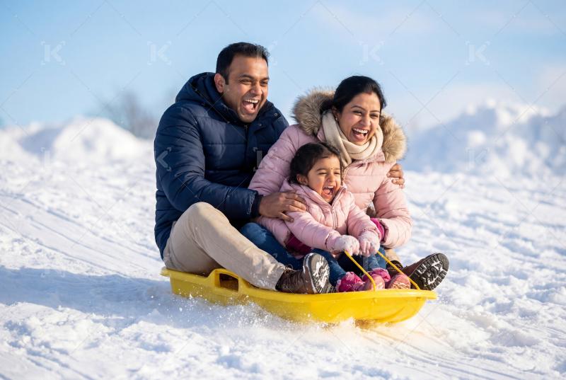 Happy indian family enjoying together at snow forest