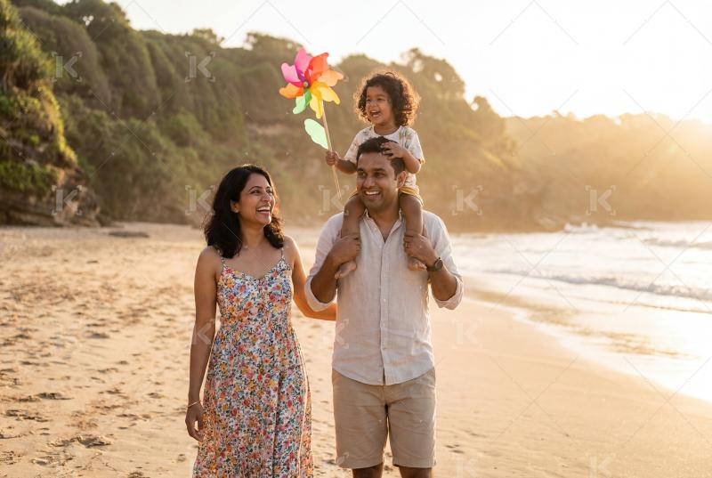 Happy indian family enjoying together at beach