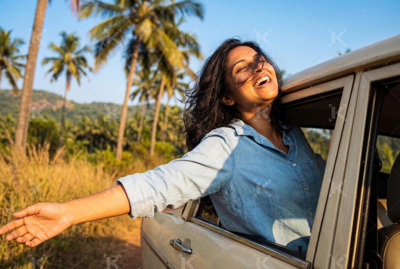 Young beautiful indian woman enjoying in the car