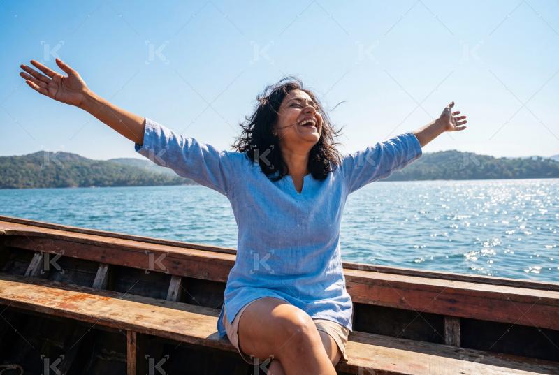Young indian woman enjoying on wooden boat in river water