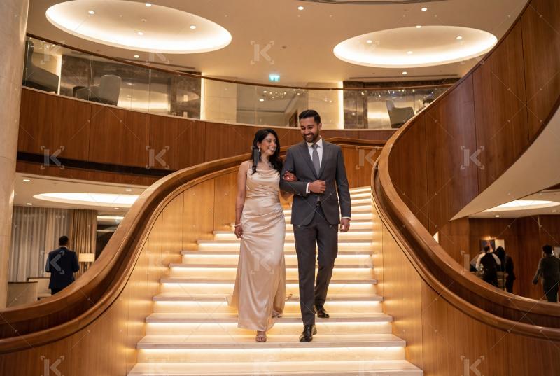 Young indian couple walking on stairs in luxurious hotel