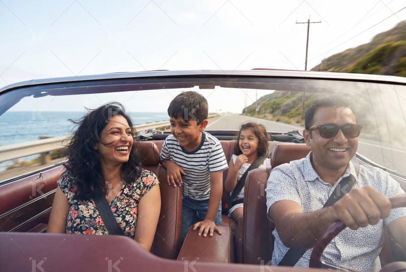 Happy indian family enjoying together in the car