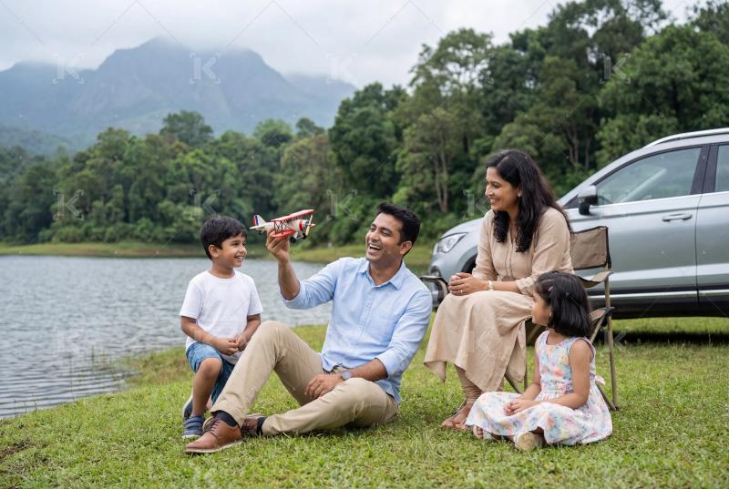 Happy indian little girl holding toy plane