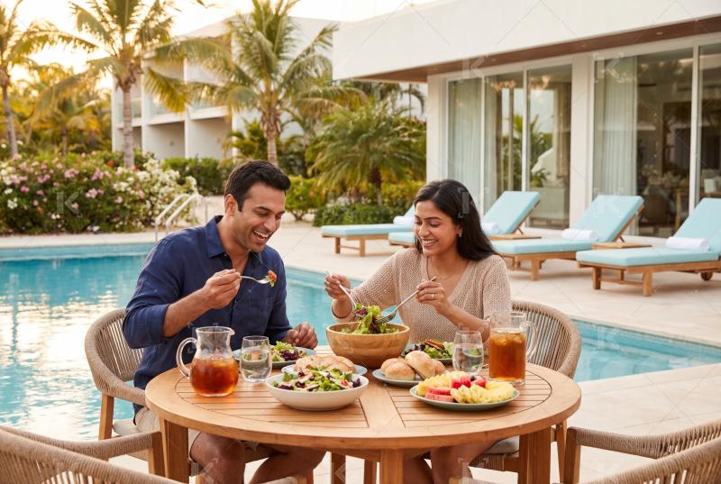 Happy indian couple enjoying a relaxed outdoor meal together