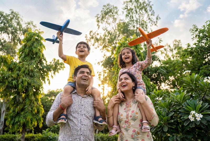Happy indian little girl holding toy plane