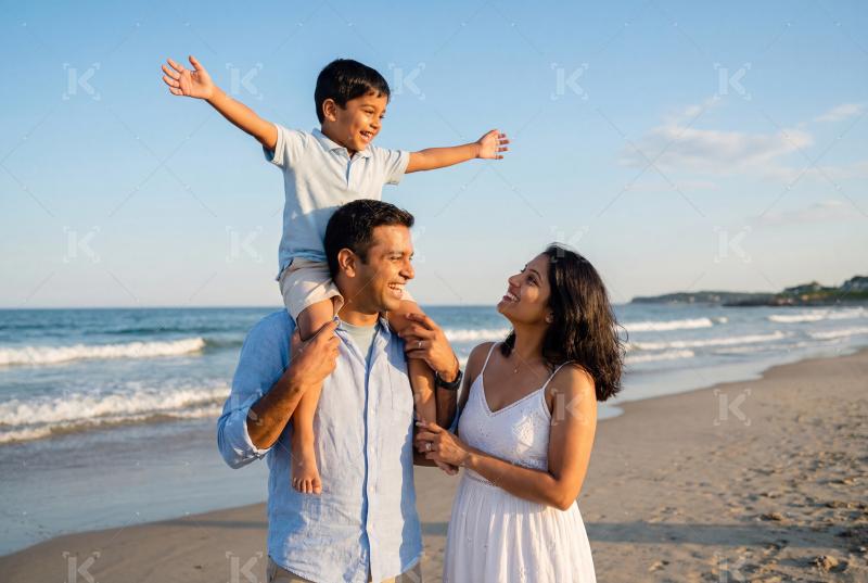 Happy indian family enjoying on sea beach