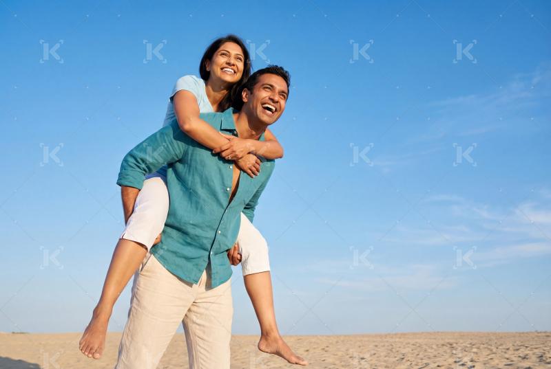Happy indian family enjoying on sea beach