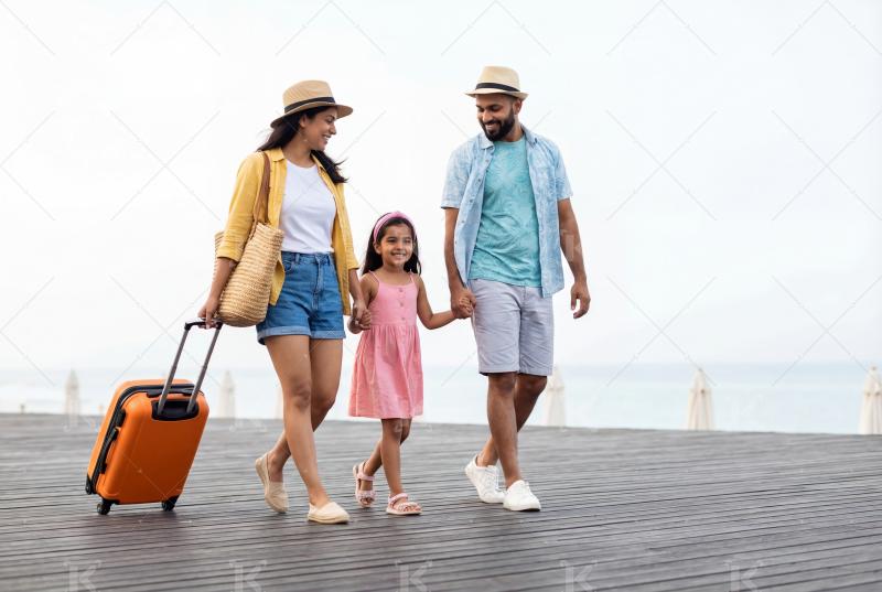 Happy indian family walking with travelling bag