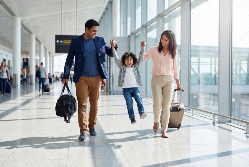 Happy indian family walking with travelling bag