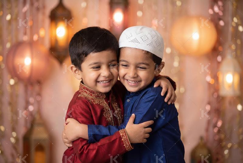 Happy indian little boys hug to each other on Eid Festival
