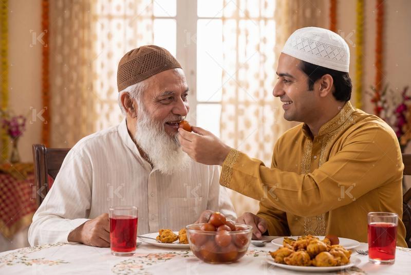Happy indian man feeding to his father sweet on Eid festival
