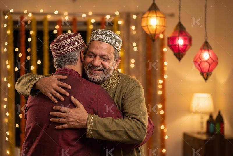 Two Muslim men warmly embracing each other in celebration, shari