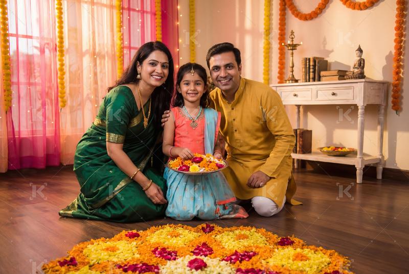 Happy indian family celebrating traditional festival together at