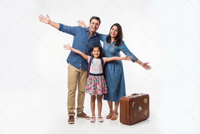 Happy indian family standing with suitcase ready for travel