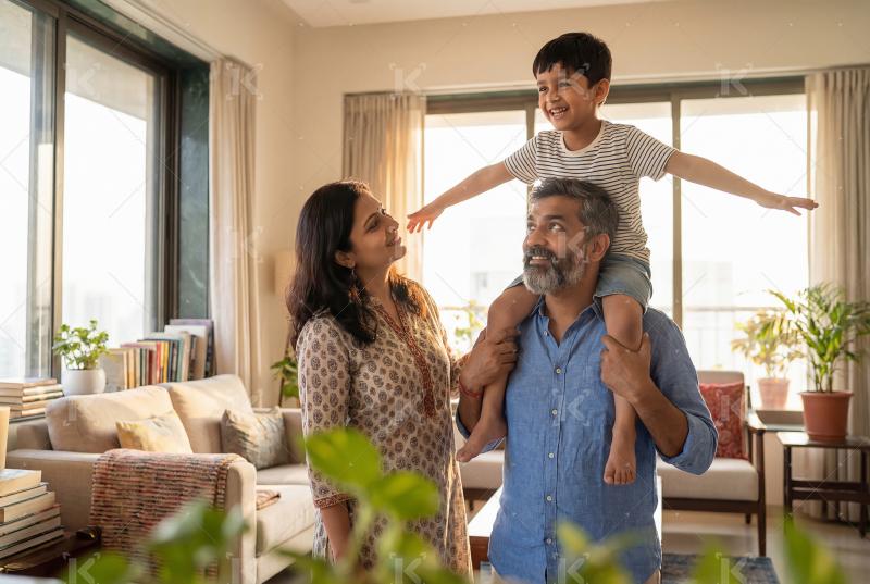 Joyful indian family moment where a father carries his smiling s
