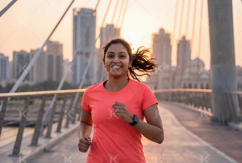 Young indian woman jogging at street