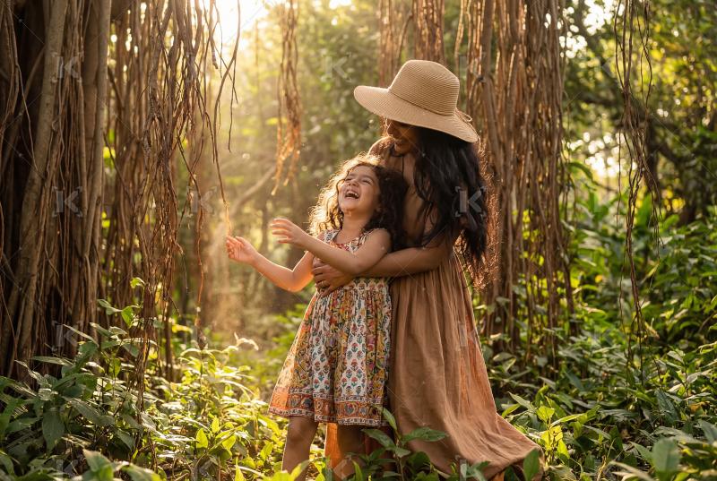 Happy indian mother and daughter enjoying together at park
